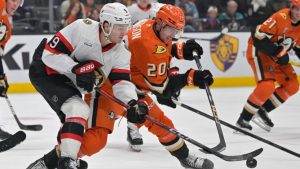 Ottawa Senators center Josh Norris (9) and Anaheim Ducks right wing Brett Leason (20) battle for the puck during the second period of an NHL hockey game. (Jayne-Kamin-Oncea/AP)