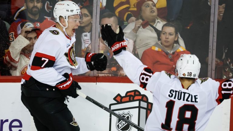 Ottawa Senators' Brady Tkachuk, left, celebrates his game-winning goal with teammate Tim Stutzle during overtime NHL hockey action against the Calgary Flames in Calgary on Thursday, Dec. 19, 2024. (Jeff McIntosh/CP)