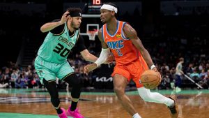 Charlotte Hornets guard Seth Curry (30) guards Oklahoma City Thunder guard Shai Gilgeous-Alexander (2) during the first half of an NBA basketball game in Charlotte, N.C., Saturday, Dec. 28, 2024. (AP Photo/Jacob Kupferman)