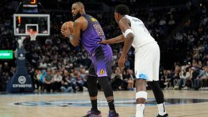 Los Angeles Lakers forward LeBron James (23) handles the ball as Minnesota Timberwolves guard Anthony Edwards (5) defends during the first half of an NBA basketball game, Monday, Dec. 2, 2024, in Minneapolis. (AP Photo/Abbie Parr)