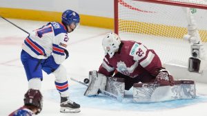 USA defenceman Cole Hutson (24) pressures Latvia goaltender Linards Feldbergs (29) as he makes a save during first period IIHF World Junior Hockey Championship tournament action, Saturday, Dec. 28, 2024 in Ottawa. (Adrian Wyld/CP)