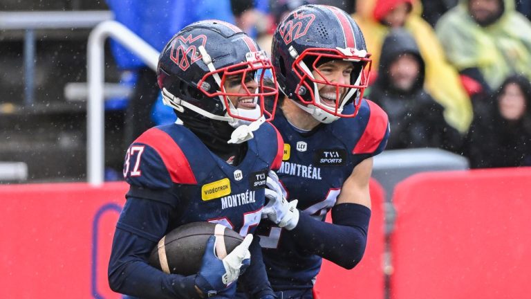 Montreal Alouettes' Wesley Sutton (37) reacts with teammate Marc-Antoine Dequoy (24) after catching an interception during second half CFL action against the Ottawa Redblacks in Montreal, Monday, Oct. 14, 2024. (THE CANADIAN PRESS/Graham Hughes)