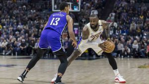 Los Angeles Lakers forward LeBron James backs up Sacramento Kings forward Keegan Murray (13) at the 3-point line during the first half of an NBA basketball game Saturday, Dec. 21, 2024, in Sacramento, Calif. (Sara Nevis/AP)