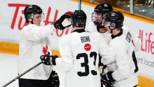 Beau Akey, left to right, Oliver Bonk, Gavin McKenna and Berkly Catton share a laugh during the first day of the Canadian World Junior Hockey Championships selection camp in Ottawa on Tuesday, Dec. 10, 2024. (Sean Kilpatrick/CP)