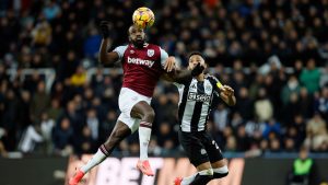 West Ham United's Michail Antonio, left, and Newcastle United's Lloyd Kelly, right, challenge for the ball during the English Premier League soccer match between Newcastle United and West Ham United in Newcastle, England, Monday, Nov. 25, 2024. (Richard Sellers/PA via AP)