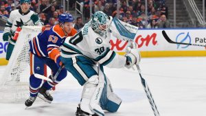 Yaroslav Askarov of the San Jose Sharks plays the puck during the second period of the game against the Edmonton Oilers at Rogers Place on December 21, 2024, in Edmonton. (Andy Devlin/NHLI via Getty Images)