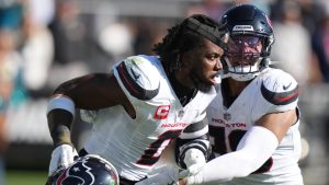 A teammates hold back Houston Texans linebacker Azeez Al-Shaair (0) from another fight during an NFL football game against the Jacksonville Jaguars, Sunday, Dec. 1, 2024, in Jacksonville, Fla. (Peter Joneleit/AP)