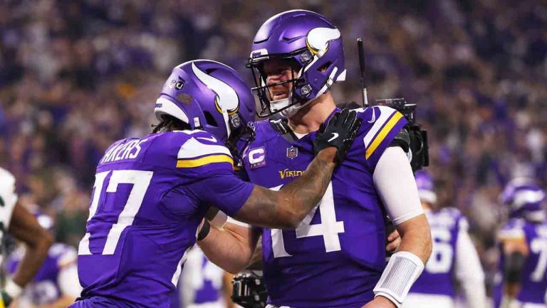 Minnesota Vikings' Sam Darnold congratulates Cam Akers on a touchdown catch during the second half of an NFL football game against the Green Bay Packers Sunday, Dec. 29, 2024, in Minneapolis. (Bruce Kluckhohn/AP)