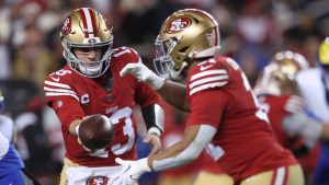 San Francisco 49ers quarterback Brock Purdy (13) hands off to running back Isaac Guerendo during the first half of an NFL football game against the Los Angeles Rams in Santa Clara, Calif., Thursday, Dec. 12, 2024. (Jed Jacobsohn/AP)