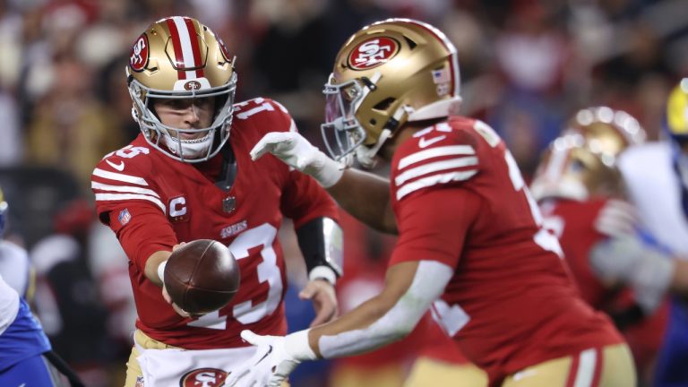 San Francisco 49ers quarterback Brock Purdy (13) hands off to running back Isaac Guerendo during the first half of an NFL football game against the Los Angeles Rams in Santa Clara, Calif., Thursday, Dec. 12, 2024. (Jed Jacobsohn/AP)