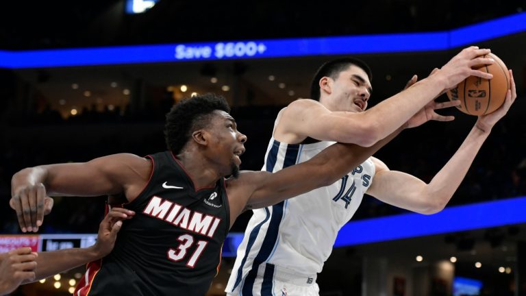 Memphis Grizzlies centre Zach Edey (14) handles the ball against Miami Heat centre Thomas Bryant (31) in the first half of an NBA pre-season basketball game Friday, Oct. 18, 2024, in Memphis, Tenn. (Brandon Dill/AP)