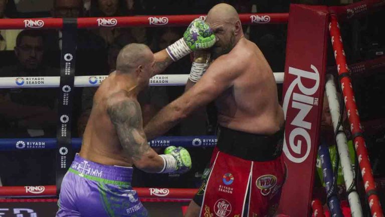 Boxers Britain's Tyson Fury, right, and Ukraine's Oleksandr Usyk compete during their WBA, WBO, and WBC world heavyweight title fight in Riyadh, Saudi Arabia, Saturday, Dec. 21, 2024. (Frank Augstein/AP)