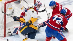 Montreal Canadiens goaltender Sam Montembeault (35) makes a save against Nashville Predators' Filip Forsberg (9) as Canadiens' Arber Xhekaj (72) and Mike Matheson (8) skate in to defend during second period NHL hockey action in Montreal on Thursday, Dec. 5, 2024. (Christinne Muschi/CP)