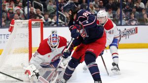 Montreal Canadiens goalie Sam Montembeault, left, makes a stop in front of Columbus Blue Jackets forward Kirill Marchenko, center, and defenseman Lane Hutson during the second period of an NHL hockey game in Columbus, Ohio, Monday, Dec. 23, 2024. (Paul Vernon/AP)