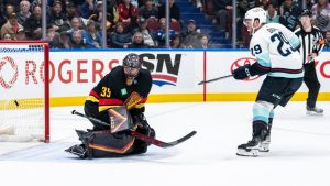 Seattle Kraken's Vince Dunn (29) scores on Vancouver Canucks goaltender Thatcher Demko (35) during overtime NHL hockey action in Vancouver, on Saturday, December 28, 2024. (Ethan Cairns/CP)