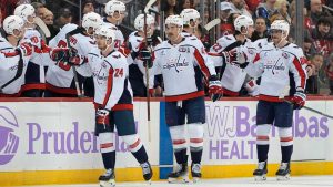 Washington Capitals' Connor McMichael, left, Tom Wilson, center, and Pierre-Luc Dubois, right, celebrate after McMichael scored during the second period of an NHL hockey game against the New Jersey Devils. (Pamela Smith/AP)