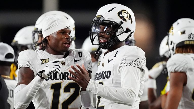 Colorado wide receiver Travis Hunter, left, confers with quarterback Shedeur Sanders in the second half of an NCAA college football game against Colorado State, Saturday, Sept. 14, 2024, in Fort Collins, Colo. (David Zalubowski/AP Photo)