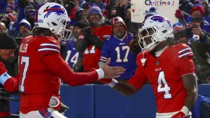 Buffalo Bills quarterback Josh Allen (17) congratulates Buffalo Bills running back James Cook (4) after a touchdown against the New England Patriots during the third quarter of an NFL football game, Sunday, Dec. 22, 2024, in Orchard Park, N.Y.. (Jeffrey T. Barnes/AP)