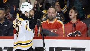 Boston Bruins' David Pastrnak celebrates his game-winning goal in overtime against the Calgary Flames NHL hockey action in Calgary on Tuesday, Dec. 17, 2024. (Jeff McIntosh/CP)