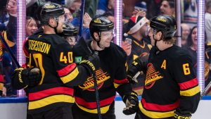 Vancouver Canucks' Jake DeBrusk (74) celebrates his goal against the Columbus Blue Jackets with teammates during the third period of an NHL hockey game in Vancouver, on Friday, December 6, 2024. (Ethan Cairns/THE CANADIAN PRESS)