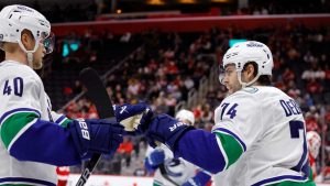 Vancouver Canucks left wing Jake DeBrusk (74) celebrates after his goal against the Detroit Red Wings with center Elias Pettersson (40) during the second period of an NHL hockey game. (Duane Burleson/AP)