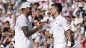 Serbia's Novak Djokovic, right, celebrates beating Australia's Nick Kyrgios in the final of the men's singles on day fourteen of the Wimbledon tennis championships in London, Sunday, July 10, 2022. (Kirsty Wigglesworth/AP)