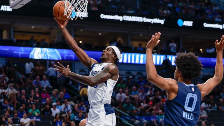 Former Dallas Mavericks forward Emanuel Miller, left, lays the ball up during an NBA pre-season basketball game against the Memphis Grizzlies in Dallas, Monday, Oct. 7, 2024. (Gareth Patterson/AP)