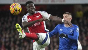 Arsenal's Bukayo Saka, left, kicks the ball ahead of Everton's Vitaliy Mykolenko during the English Premier League soccer match between Arsenal and Everton at Emirates Stadium in London, Saturday, Dec. 14, 2024. (Kin Cheung/AP)