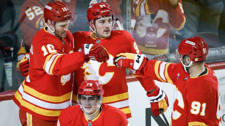 Calgary Flames' Jonathan Huberdeau (10) celebrates his goal with teammates during first period NHL hockey action against the Tampa Bay Lightning. (Jeff McIntosh/CP)