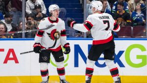 Ottawa Senators' Jake Sanderson (85) celebrates his game winning goal with Brady Tkachuk (7) after overtime NHL hockey action against the Vancouver Canucks. (Ethan Cairns/CP)