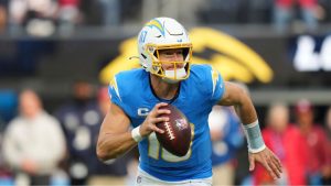 Los Angeles Chargers quarterback Justin Herbert (10) rolls out during the first half an NFL football game against the Tampa Bay Buccaneers, Sunday, Dec. 15, 2024, in Inglewood, Calif. (Eric Thayer/AP)