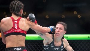 Jamey-Lyn Horth, right, takes a punch from Ivana Petrovic during the women's flyweight bout at UFC Fight Night in Edmonton on Saturday, Nov. 2, 2024. (Jason Franson/CP)
