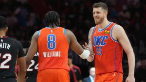 Oklahoma City Thunder forward Jalen Williams (8) and centre Isaiah Hartenstein (55) celebrate during a timeout during the second half of an NBA basketball game against the Miami Heat, Friday, Dec. 20, 2024, in Miami. (Marta Lavandier/AP)