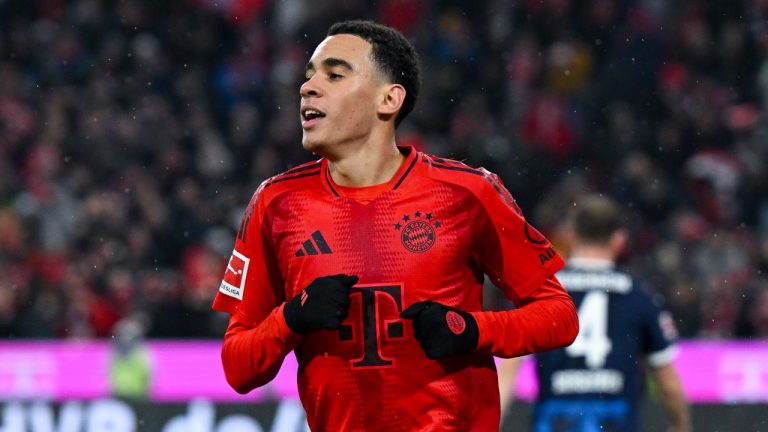 Munich's Jamal Musiala celebrates after scoring his side's fourth goal during the German Bundesliga soccer match between FC Bayern Munich and 1. FC Heidenheim 1846 in Munich, Germany, Saturday, Dec. 7, 2024. (Sven Hoppe/dpa via AP)