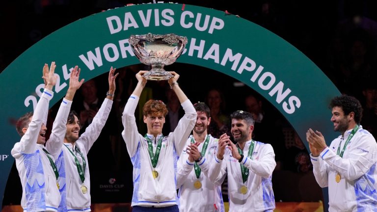 Italy's Jannik Sinner, centre, holds the Davis Cup trophy by teammates after the final between Netherlands and Italy at the Martin Carpena Sports Hall in Malaga, southern Spain, as Italy wins its second consecutive Davis Cup title, Sunday, Nov. 24, 2024. (Manu Fernandez/AP)