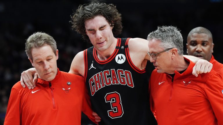 Chicago Bulls' Josh Giddey (3) is helped off the court by medical staff during second half NBA basketball action against the Toronto Raptors in Toronto on Monday, December 16, 2024. (Frank Gunn/CP)