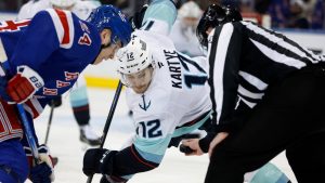 New York Rangers' Kaapo Kakko (24) faces off against Seattle Kraken's Tye Kartye (12) during an NHL hockey game, Sunday, Dec. 8, 2024, in New York. (Rich Schultz/AP)