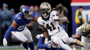 New Orleans Saints running back Alvin Kamara (41) carries the ball against New York Giants linebacker Darius Muasau (53) during the second quarter of an NFL football game, Sunday, Dec. 8, 2024, in East Rutherford, N.J. (Adam Hunger/AP)