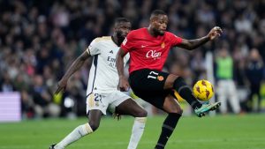 Real Madrid's Antonio Rudiger fights for the ball with Mallorca's Cyle Larin during the Spanish La Liga soccer match between Real Madrid and Mallorca at the Santiago Bernabeu stadium in Madrid, Spain, on Wednesday, January 3, 2024. (Bernat Armangue/AP)