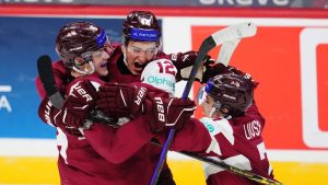 Latvia's Eriks Mateiko (left) celebrates his game-winning shootout goal against Canada with Toms Mots (12) and Davids Livsics (7) in IIHF World Junior Hockey Championship preliminary round action in Ottawa on Friday, Dec. 27, 2024. (Sean Kilpatrick/THE CANADIAN PRESS)