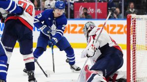 Washington Capitals goaltender Logan Thompson (48) makes a save as Toronto Maple Leafs' Matthew Knies (23) looks for the rebound during second period NHL hockey action in Toronto on Saturday, Dec. 28, 2024. (Frank Gunn/CP)