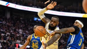 Los Angeles Lakers forward LeBron James (23) gets fouled by Golden State Warriors guard Gary Payton II (0) during the first half of an NBA basketball game Wednesday, Dec. 25, 2024, in San Francisco. (Eakin Howard/AP Photo)