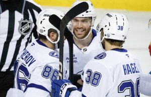 Tampa Bay Lightning's Brayden Point, centre, celebrates his goal with teammates during second second NHL hockey action against the Calgary Flames in Calgary, Alta., Thursday, Dec. 12, 2024. (Jeff McIntosh/CP)