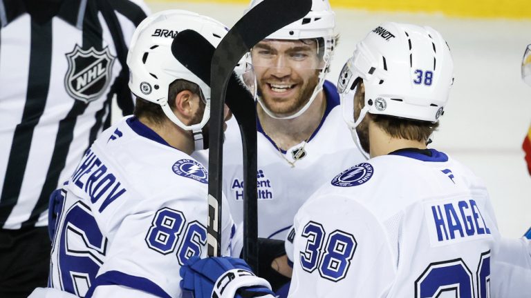 Tampa Bay Lightning's Brayden Point, centre, celebrates his goal with teammates during second second NHL hockey action against the Calgary Flames in Calgary, Alta., Thursday, Dec. 12, 2024. (Jeff McIntosh/CP)