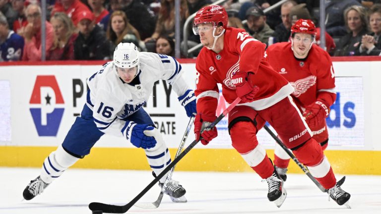 Detroit Red Wings left wing Lucas Raymond (23) skates the puck past Toronto Maple Leafs right wing Mitch Marner (16) during the second period of an NHL hockey game, Saturday, Dec. 14, 2024 in Detroit. (Lon Horwedel/AP)