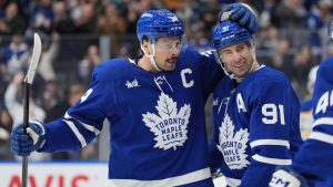 Toronto Maple Leafs centre John Tavares (91) celebrates his goal against the Buffalo Sabres with teammates Auston Matthews (34) and Morgan Rielly (44) during second period NHL hockey action in Toronto, Sunday, Dec. 15, 2024. (Frank Gunn/CP)