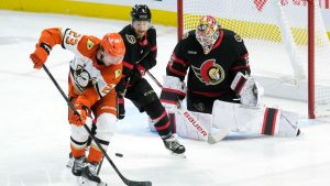 Anaheim Ducks' Mason McTavish tries to tip a shot past Ottawa Senators goaltender Linus Ullmark as he is pressured by Senators' Nick Jensen during first period NHL action, Wednesday, Dec. 11, 2024 in Ottawa. (Adrian Wyld/CP)