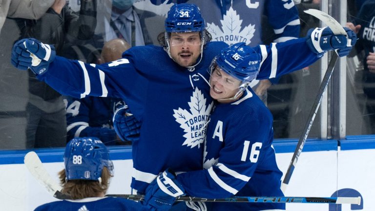 Toronto Maple Leafs centre Auston Matthews (34) celebrates his goal with teammates Mitchell Marner (16) and William Nylander (88) during second period, round one, NHL Stanley Cup playoff hockey action against the Tampa Bay Lightning, in Toronto, Monday, May 2, 2022. (Frank Gunn/THE CANADIAN PRESS)