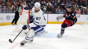 Toronto Maple Leafs forward Max Pacioretty, left, chases the puck in front of Columbus Blue Jackets forward Adam Fantilli during an NHL hockey game in Columbus, Ohio, Tuesday, Oct. 22, 2024. The Blue Jackets won 6-2. (Paul Vernon/AP)