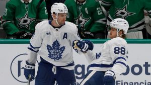 Toronto Maple Leafs centre John Tavares (91) congratulates Toronto Maple Leafs right wing William Nylander (88) after Nylander scored an open net goal against the Dallas Stars during the third period of an NHL hockey game in Dallas, Wednesday, Dec. 18, 2024. (Michael Ainsworth/AP)